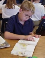 boy reading AR book